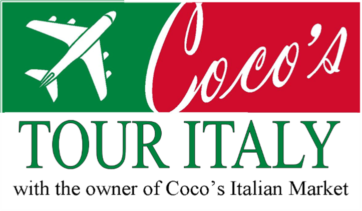 Owner of Coco's Italian Market leading a guided tour through Italy with travelers enjoying authentic cuisine and historic sites.