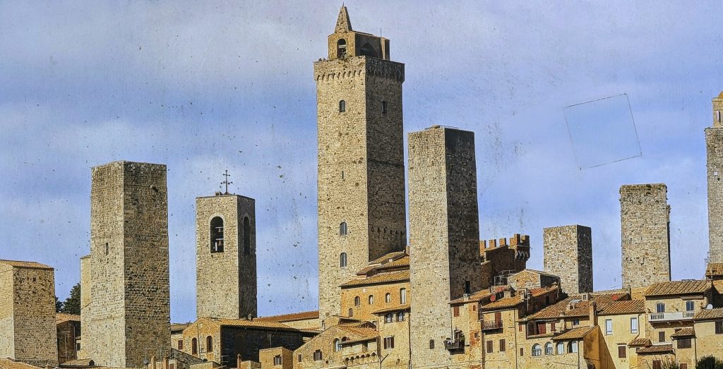 Iconic medieval towers standing tall over ancient Tuscan town.